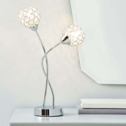 82f3fc7845ad974441b52ff2663ec9c6c8a062262091e3386279039598b30c3f-1.jpg An Image of Portia Acrylic Beaded Table Lamp Chrome