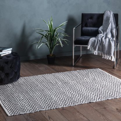 a385d22abcae076c65aae6f8bce8b97806d99328743a7f6c2f2b298a0df6c432.jpg An Image of Kishan Rug Black and white