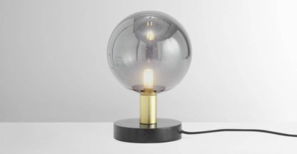 50d540ccc3bfc8f315f6d5a8c0ba1796b274ebdffe87f871eb00f417018756d1.jpg An Image of Boll Table Lamp, Black Marble, Brass & Smoked Glass