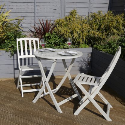 7d053cb330018bf00582e72620d9b2553d1cef887cc6a2c54fa02ba3c80977d5.jpg An Image of Acacia Washed Wood Bistro Set Washed White