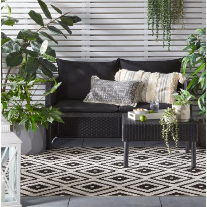 52bb29ebe8a49f067101a7d30b02e931b08e5df112e8987cbacdf6e54f2a1cc6.jpg An Image of Geometric Monochrome Indoor Outdoor Rug Black and white