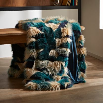 fb662542b9ed34aa0b15d22d6ab1ffd386a182eb50f6c1dcd245fd66827ae3bc.jpg An Image of Milan Faux Fur Throw Peacock