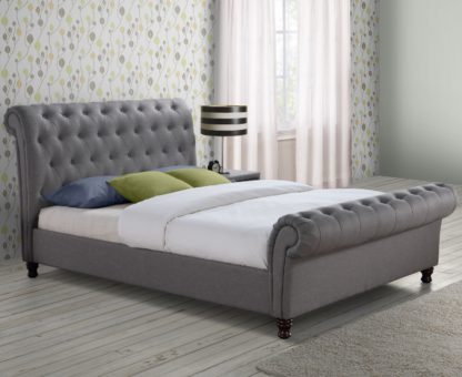 2e4609e90ec25c2f67dd676bc071bd81b1cc84f7679a98481f8a70aeace0a086-1.jpg An Image of Castello Grey Fabric Scroll Sleigh Bed Frame - 4ft6 Double