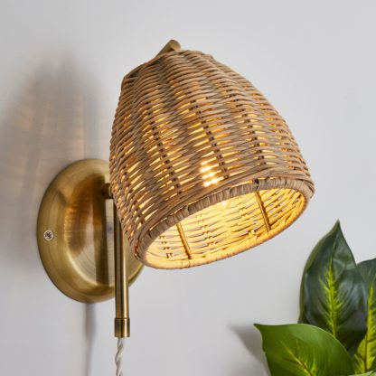 721f51f022231f30ff03f4e93aabde031d782933ab96805e300f6f4a7c3af5ec.jpg An Image of Churchgate Cotes Rattan Plug In Wall Light Brass