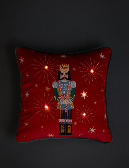 683ce577ea33f9b0df3e9ceb3e5f712e07097a4bc81cd45d66dbe9b3b3ddac2a.jpg An Image of M&S Velvet Nutcracker Small Light Up Cushion