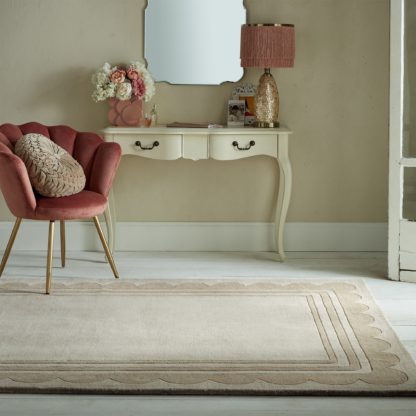 0c24baf4fbf12c06398c2692bf77fbc5f6e1d2810592aa6fbb1e80a34f4694e8.jpg An Image of Lois Scallop Border Wool Rug Natural