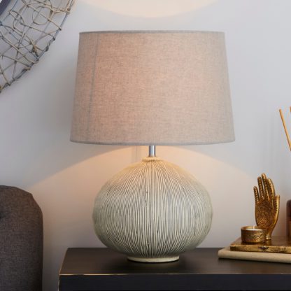 5e5ec4b40f76958944740048f5eee3660452596a163280a60d743c6020b87c50.jpg An Image of Dahlia Scratched Resin Grey Table Lamp Grey