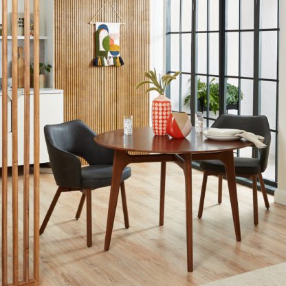 2f365e48eef5bd0f8f3dfb79a95efe74a6042910cb286b34ed4170a4f12cd4e5.jpg An Image of Alva Round Dining Table with Karin Chairs Black