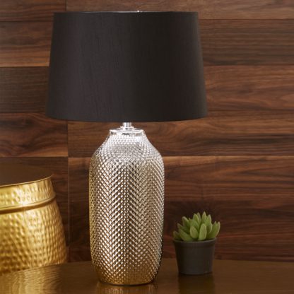 4e0d743ea1b0e13274882870921a5f67d963ad1b088faf1f1a8d651bf4cb45db.jpg An Image of Nova Textured Ceramic Table Lamp Silver