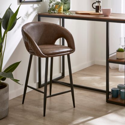 1e9e4e17513f46486d9c41252aa9abac83b8f4bf763cdac48d72416a29888090.jpg An Image of Dillon Bar Stool, Faux Leather Faux Leather Mocha