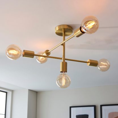 6e7f1773c15cea0e1330ceb0c8756981b9d646879de56367e6bab6be862658f4.jpg An Image of Vogue Ryker 5 Light Ceiling Fitting Brass
