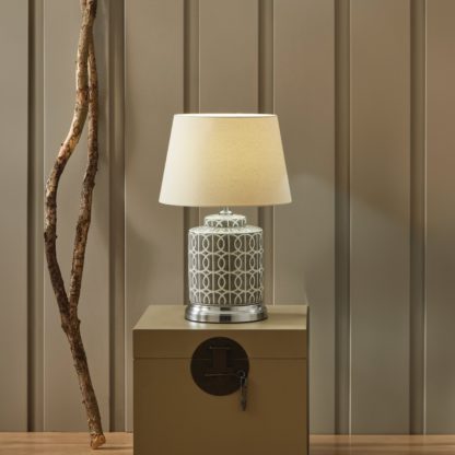 6681f37fe802434b1202038570051196492634eebb52a0bfce75d26082c8d9c7.jpg An Image of Aris Grey and White Geo Pattern Table Lamp Grey