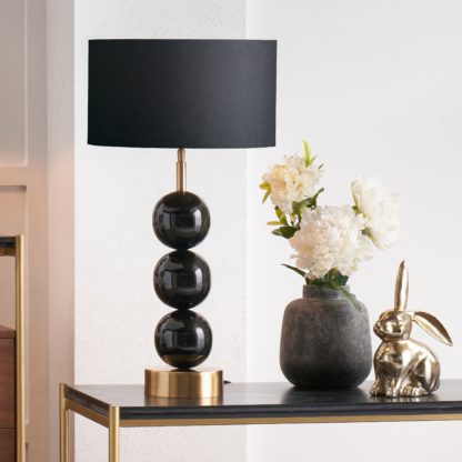 b840620309026bbcfdcc17916d4763f4f66fd8a0dc551e99b4da680c63659059.jpg An Image of Sofia Black and Gold Enamel 3 Ball Table Lamp with 35cm Harry Cylinder Drum Shade Black