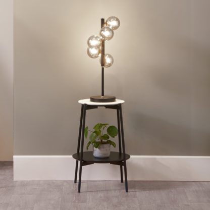 f9477b37e0f0fea0acbcb58e9c36ecd5bcc44a0077bafc44222ab62aa7a49a58.jpg An Image of Blair Smoke Glass Ball and Black Metal Table Lamp Black