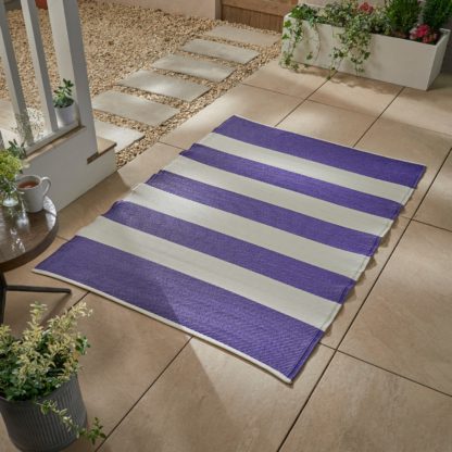 db5a23d57c113c2dff5799f1da6acd7c2d7e4e409ce72117354b4e4c0ed09651.jpg An Image of Stripe Plastic Outdoor Mat Purple