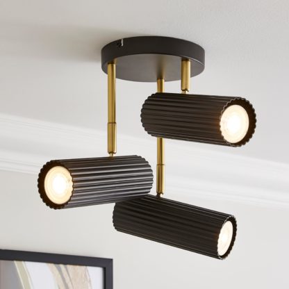 8d0518f736cd91d5395de457b424519a0e5a77ee5136ea76fdc12f96a0962d9a.jpg An Image of Georgi Industrial Ribbed 3 Light Adjustable Semi Flush Spotlight Black