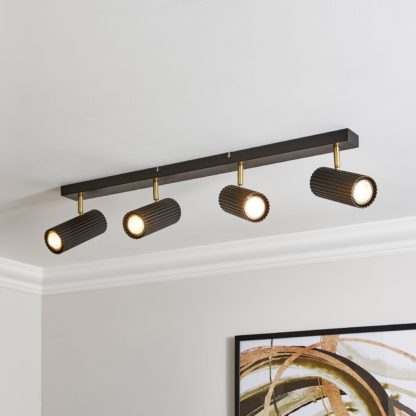 9db0882c7ce3be443db9707cd68824fb14a32e9896e9b043fb0facb304217a3a.jpg An Image of Georgi Industrial Ribbed 4 Light Adjustable Semi Flush Spotlight Bar Black